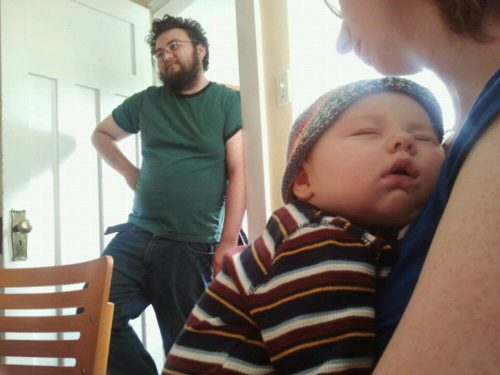 Joelle sleeps and Billy stands in doorway