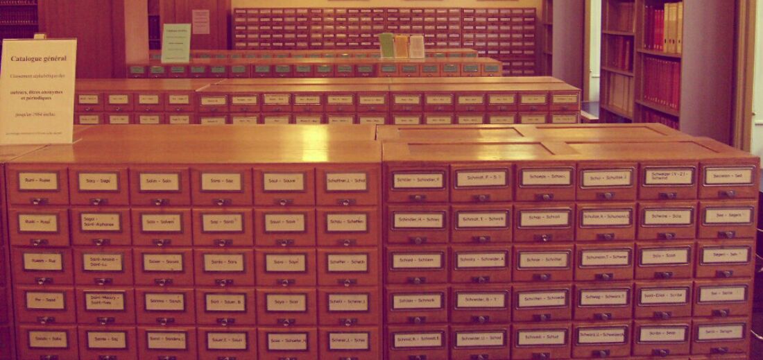 Several rows of old school card catalogues at a library