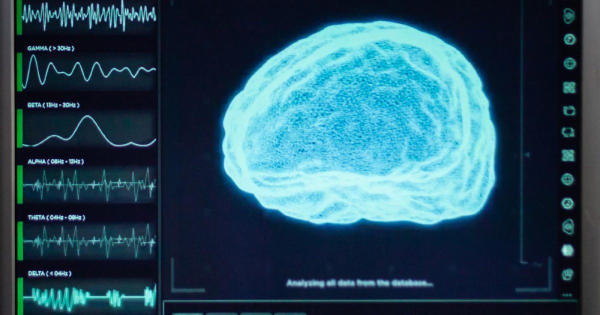A brain scan lights up bright blue on a computer screen along side of a bunch of graphs and charts.