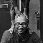 Someone is standing on Bharat's head looking adorable.